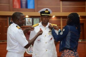 Rear Admiral Raimi and Miss Anakwe decorating Commodore Chukwuma Anakwe